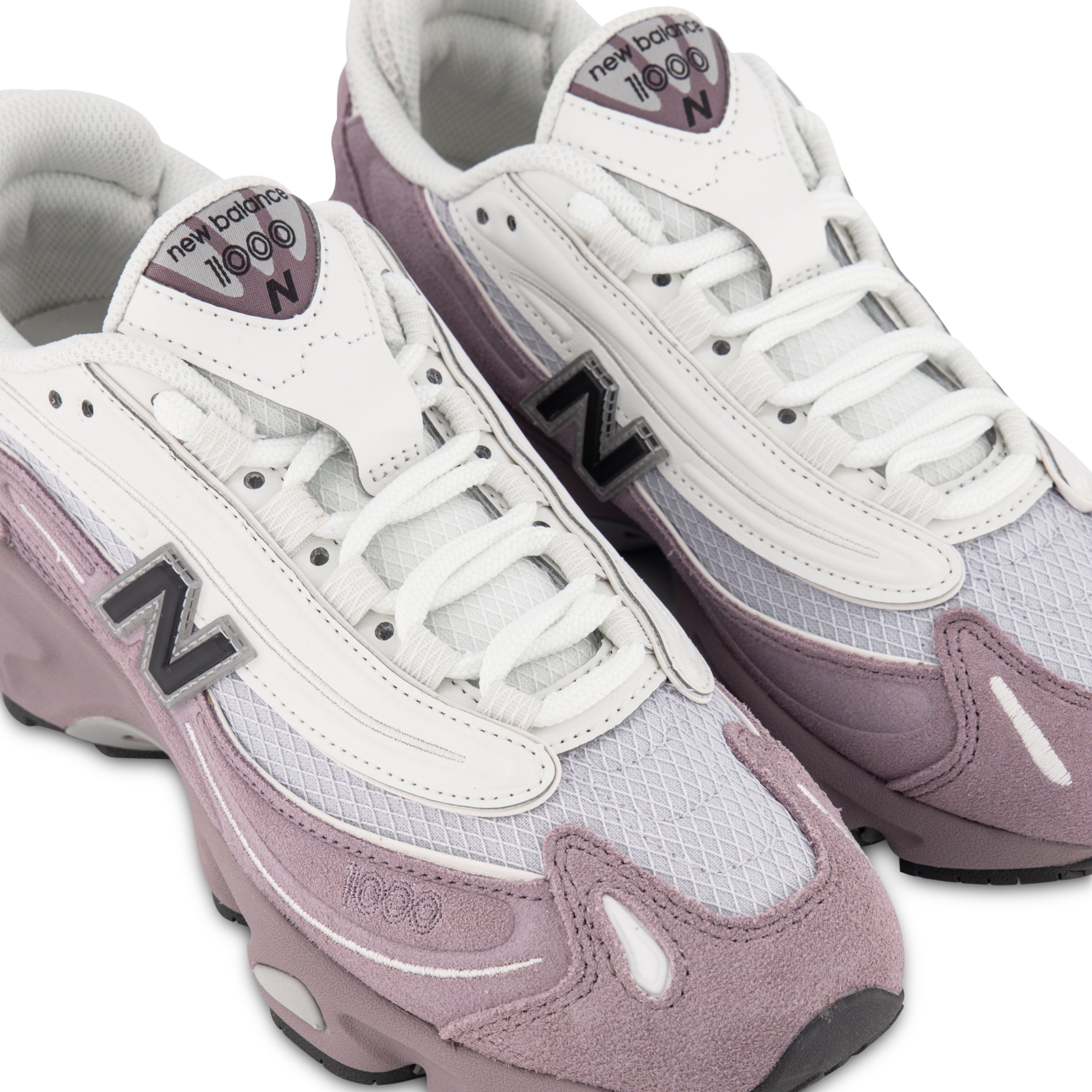 Close up of New Balance 1000 sneakers in Pale Pink & White angled right
