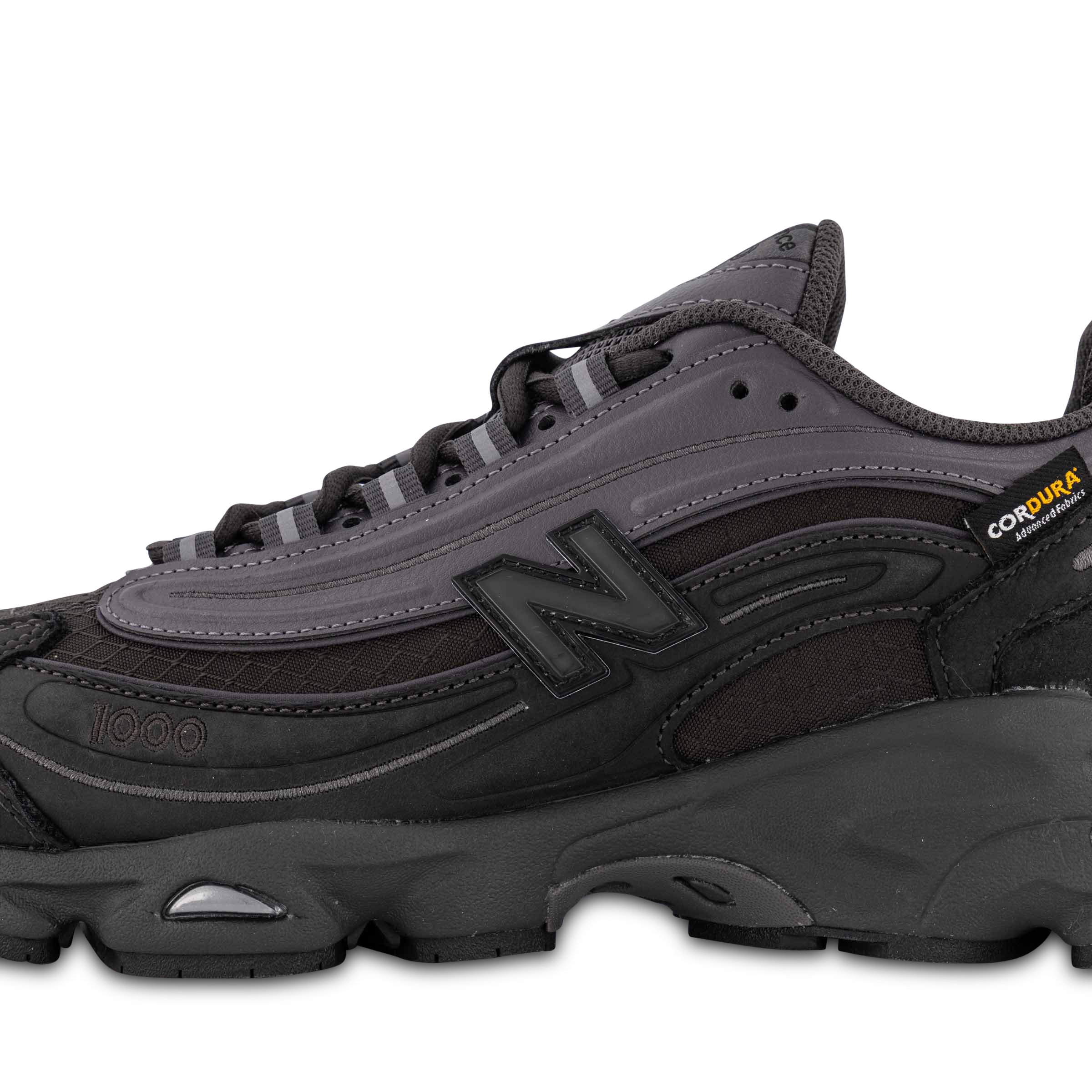 Close up of Single New Balance 1000 Sneaker in Black Cement Pointing left outside view
