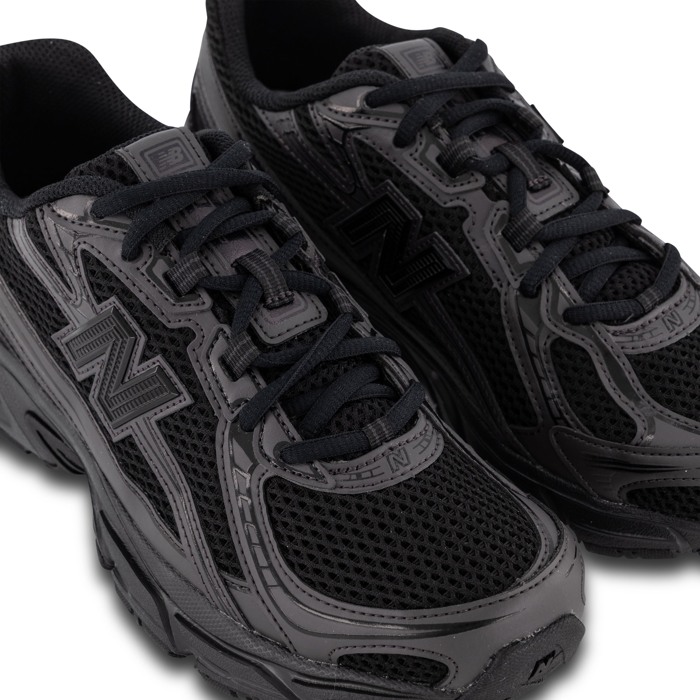 Close up of New Balance 740 sneakers in Black Cement angled right